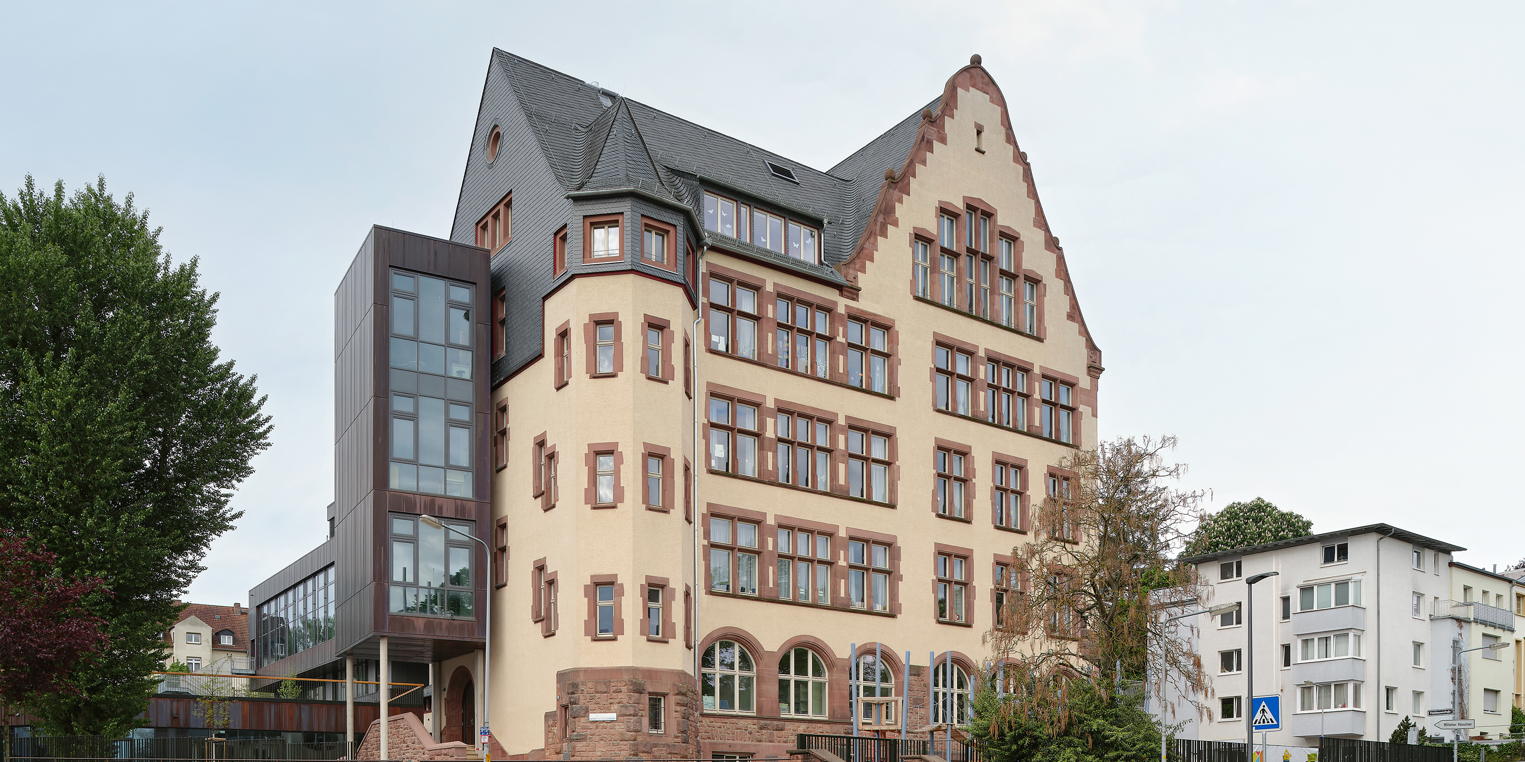 ein Altbau mit modernen Anbau an eine Straßenecke
